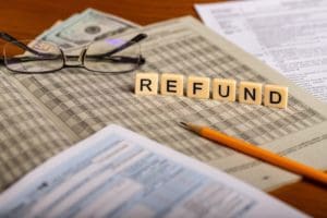 Concept image ot tax refund with forms, pencil, glasses and mone